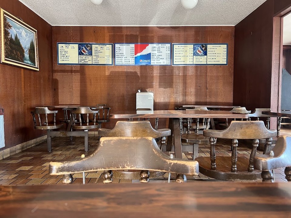 Menu board with burgers, shakes, and fries.