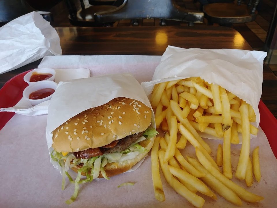 Menu board with burgers, shakes, and fries.